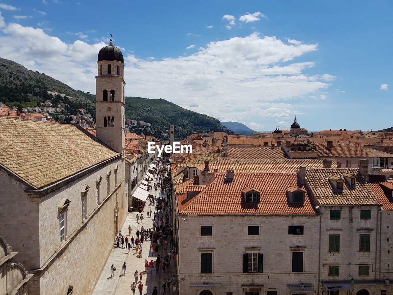 Buildings in town against sky in city