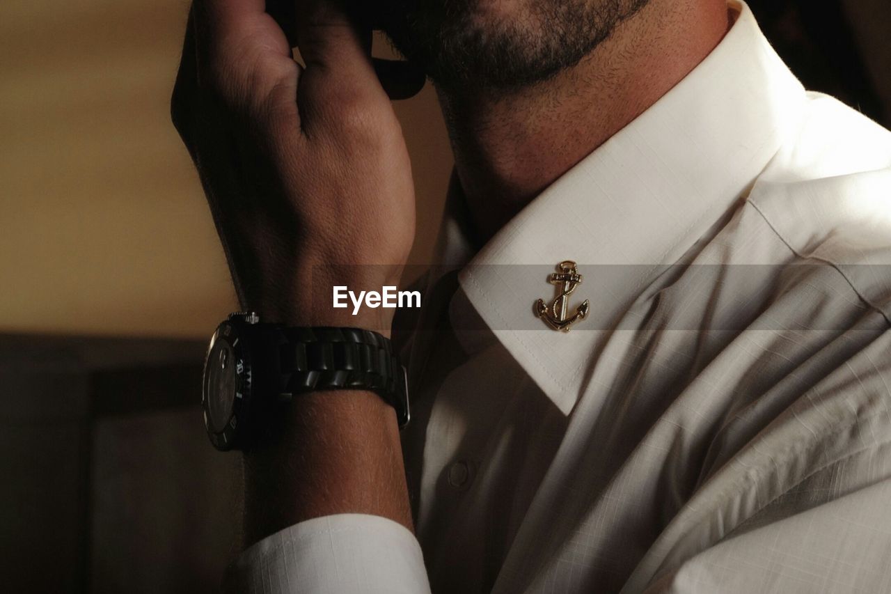 Close-up of man wearing shirt and wristwatch