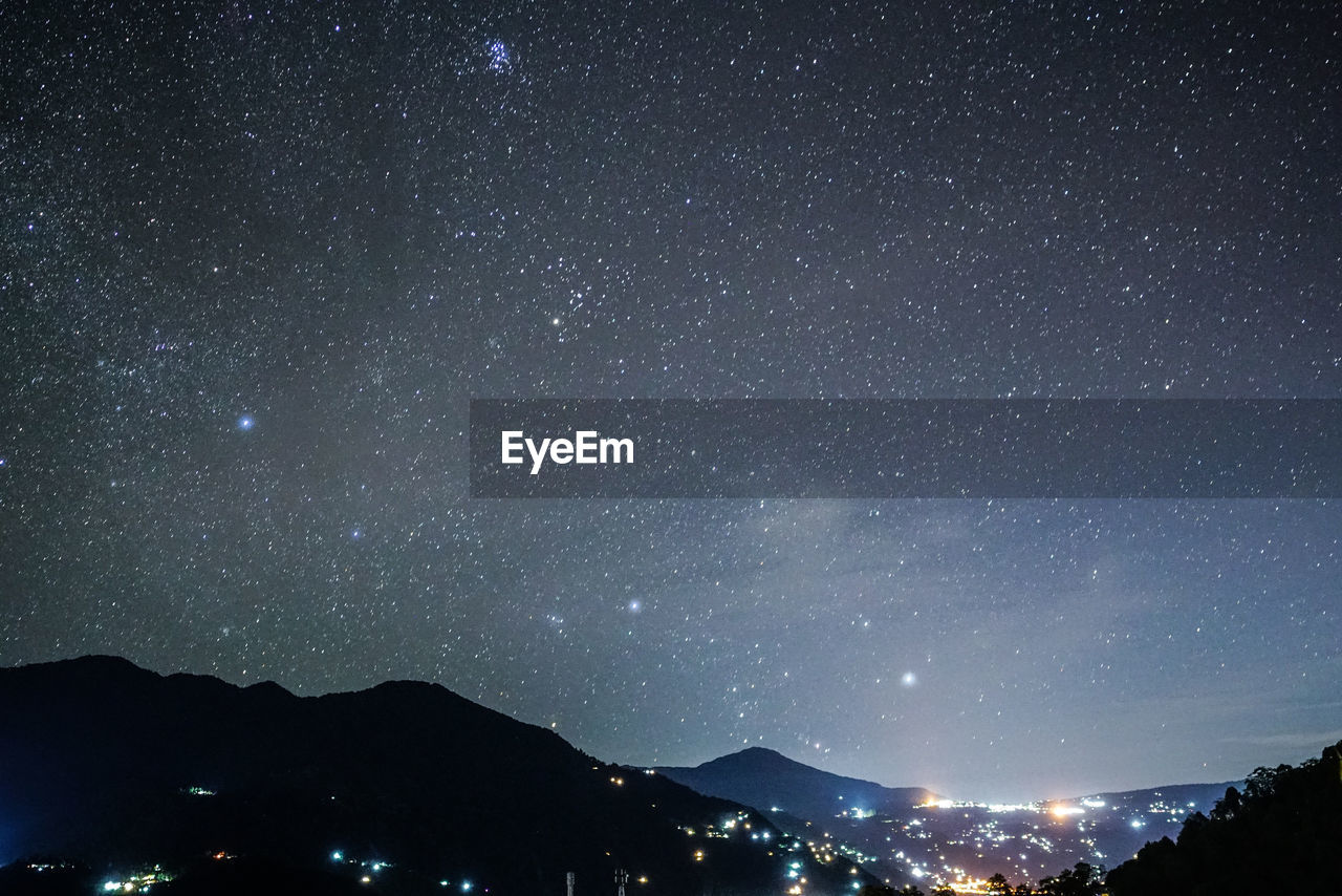 ILLUMINATED STAR FIELD AGAINST SKY AT NIGHT