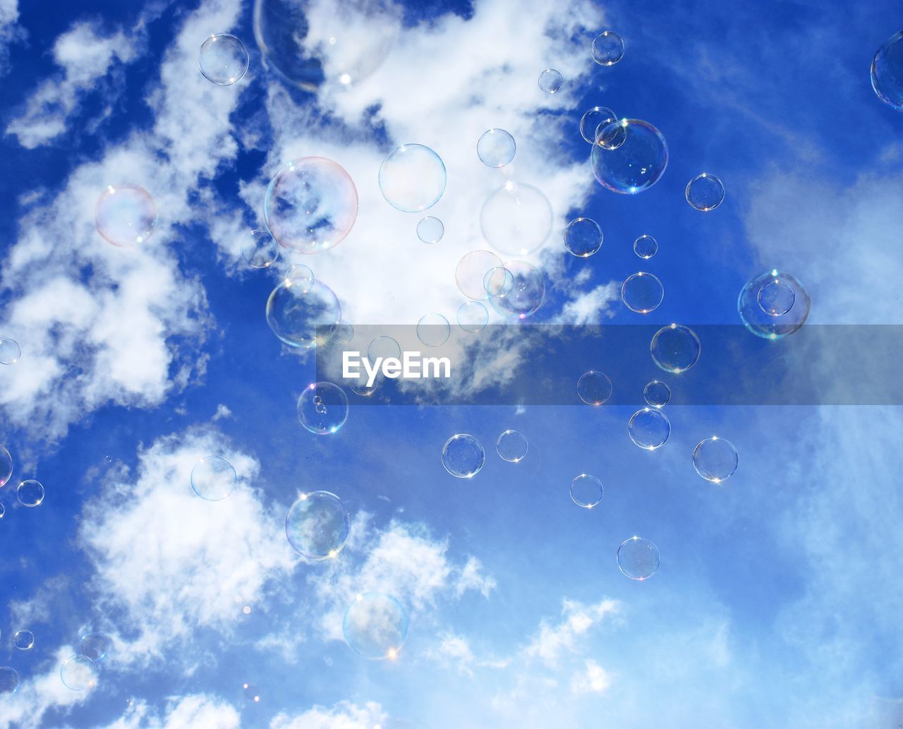 Close-up of bubbles against blue sky