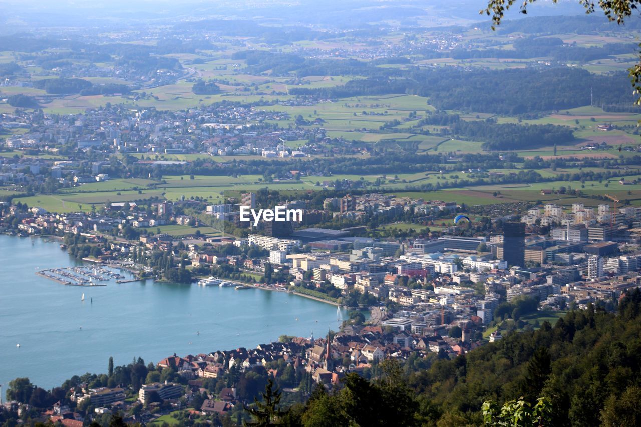 High angle view of town by river against sky