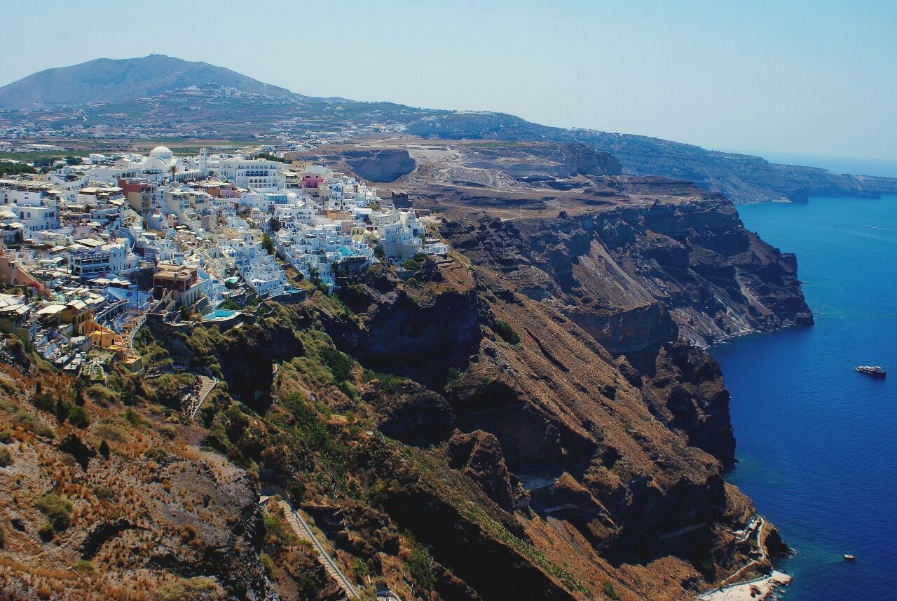 High angle view of buildings by sea against sky