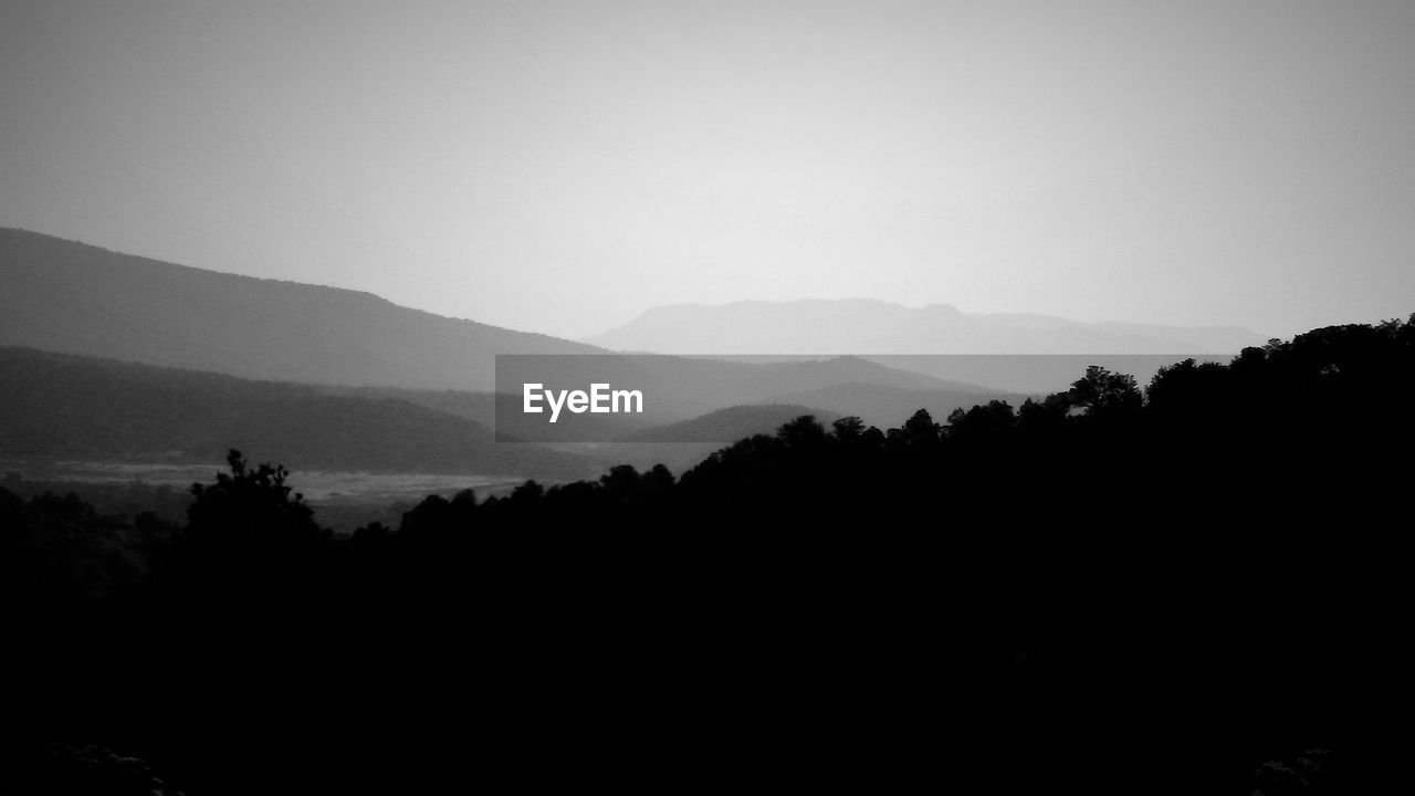 SILHOUETTE MOUNTAINS AGAINST CLEAR SKY