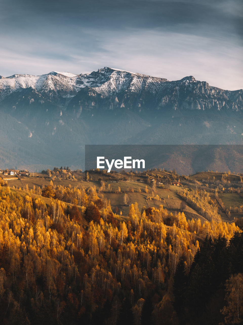 Autumn  landscape.famous alpine village and high snowy mountains in background near bran, village.