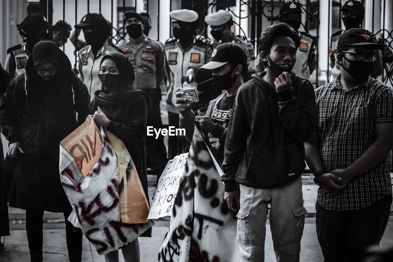 GROUP OF PEOPLE STANDING AT STORE