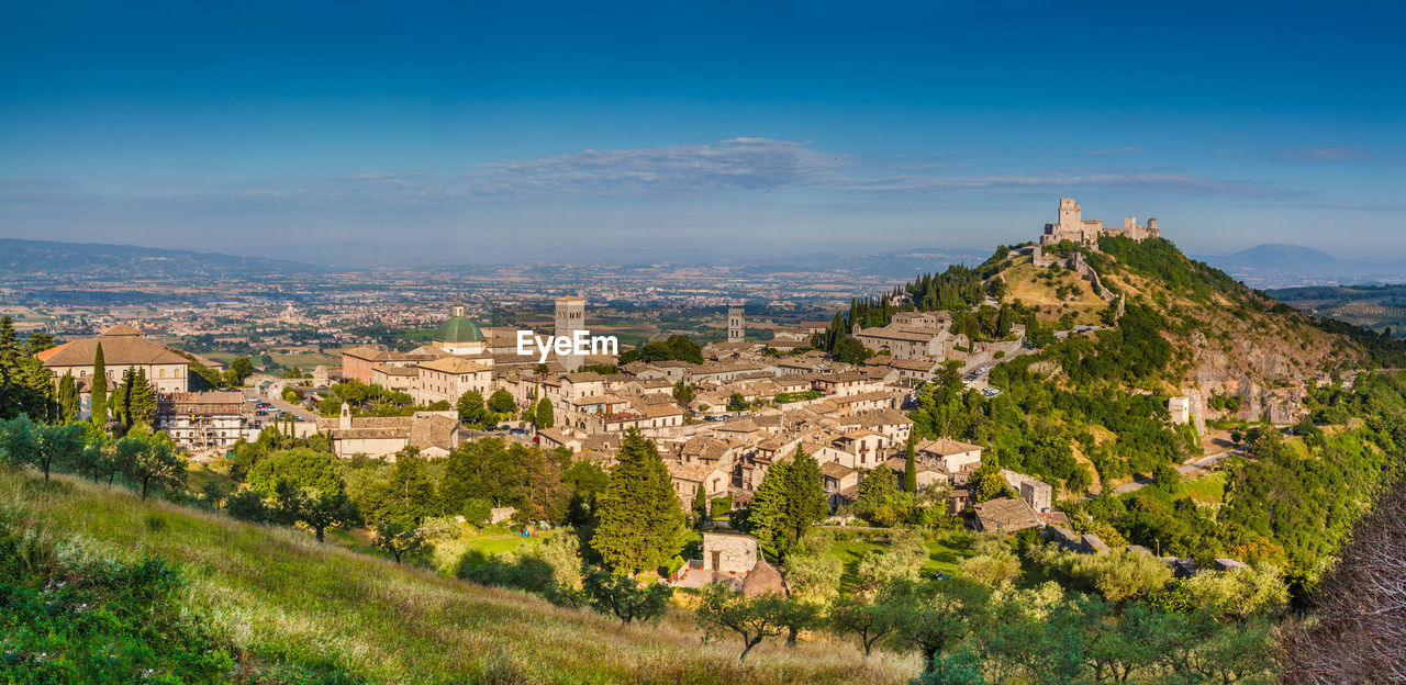 HIGH ANGLE SHOT OF TOWNSCAPE AGAINST BLUE SKY