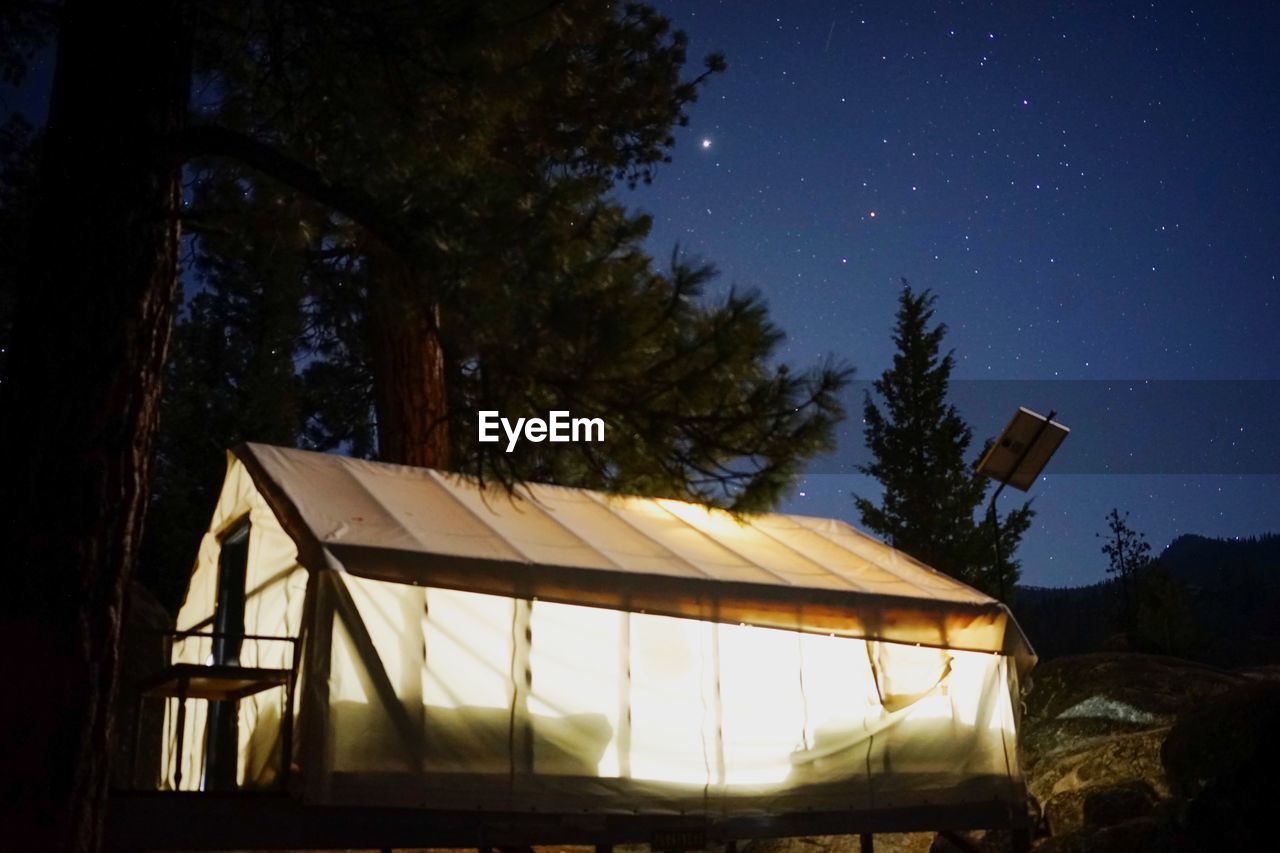 Low angle view of tent lit from inside against clear sky at night in sierra national park california