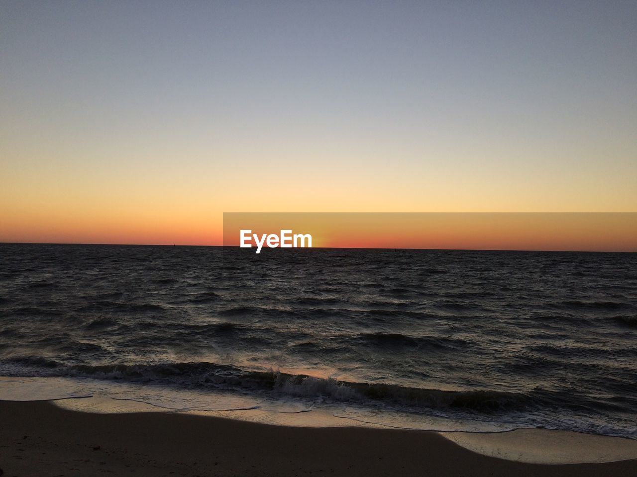 Scenic view of sea against clear sky during sunset