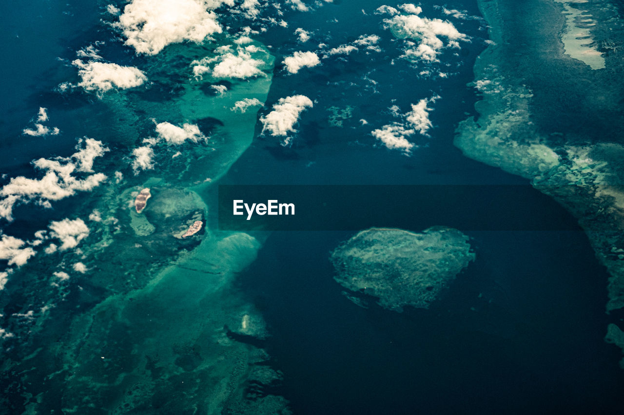 High angle view of sea with islands and reefs