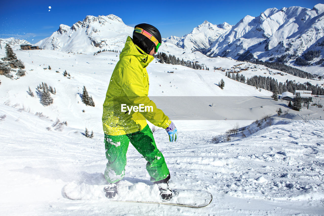 Young man skiing on snowcapped mountains during winter