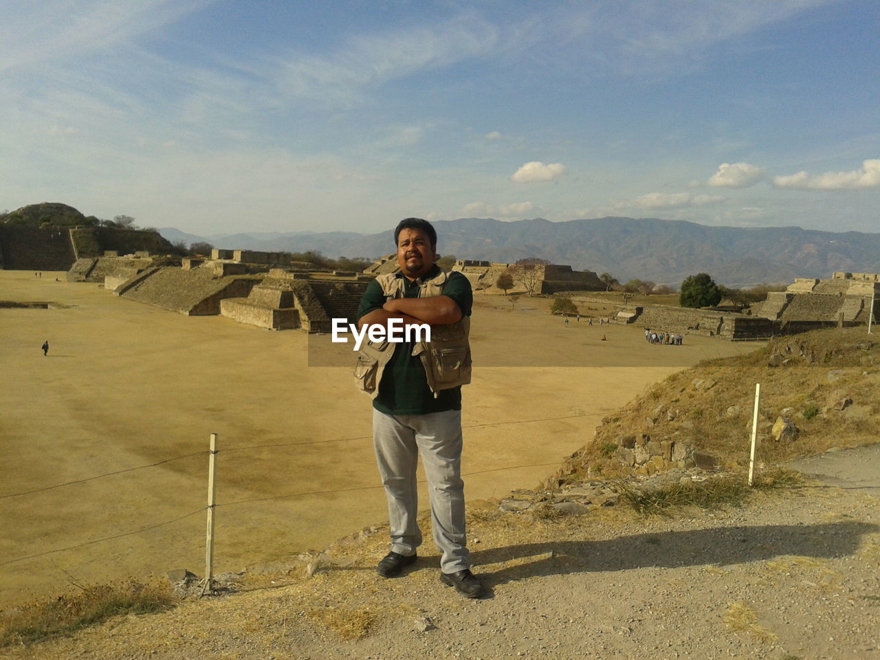 Full length portrait of man standing against landscape and sky