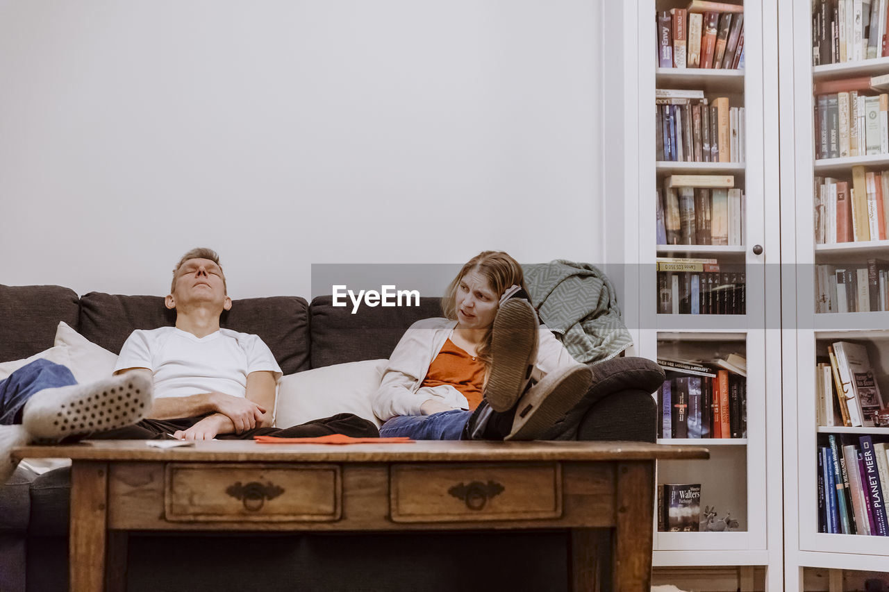 Family sitting on sofa at home