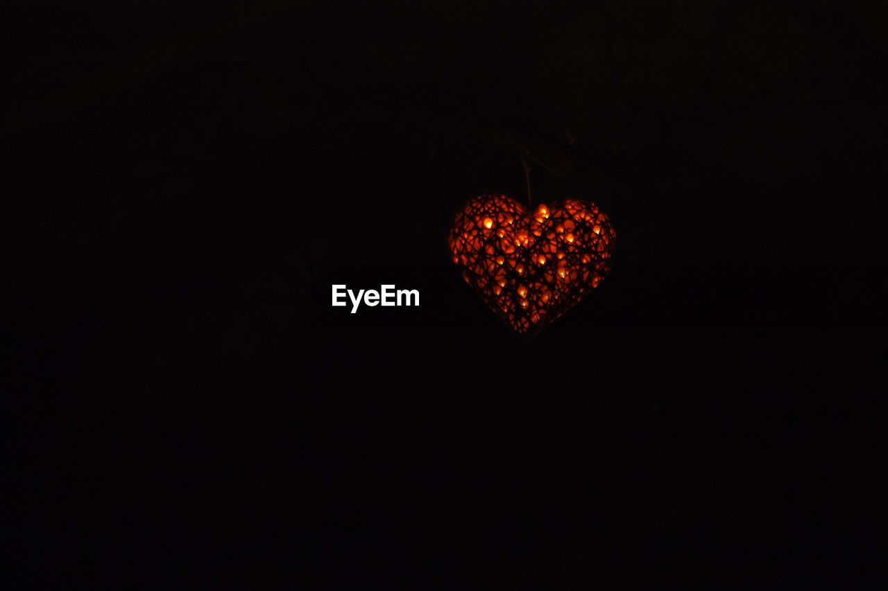 Close-up of heart shape over black background