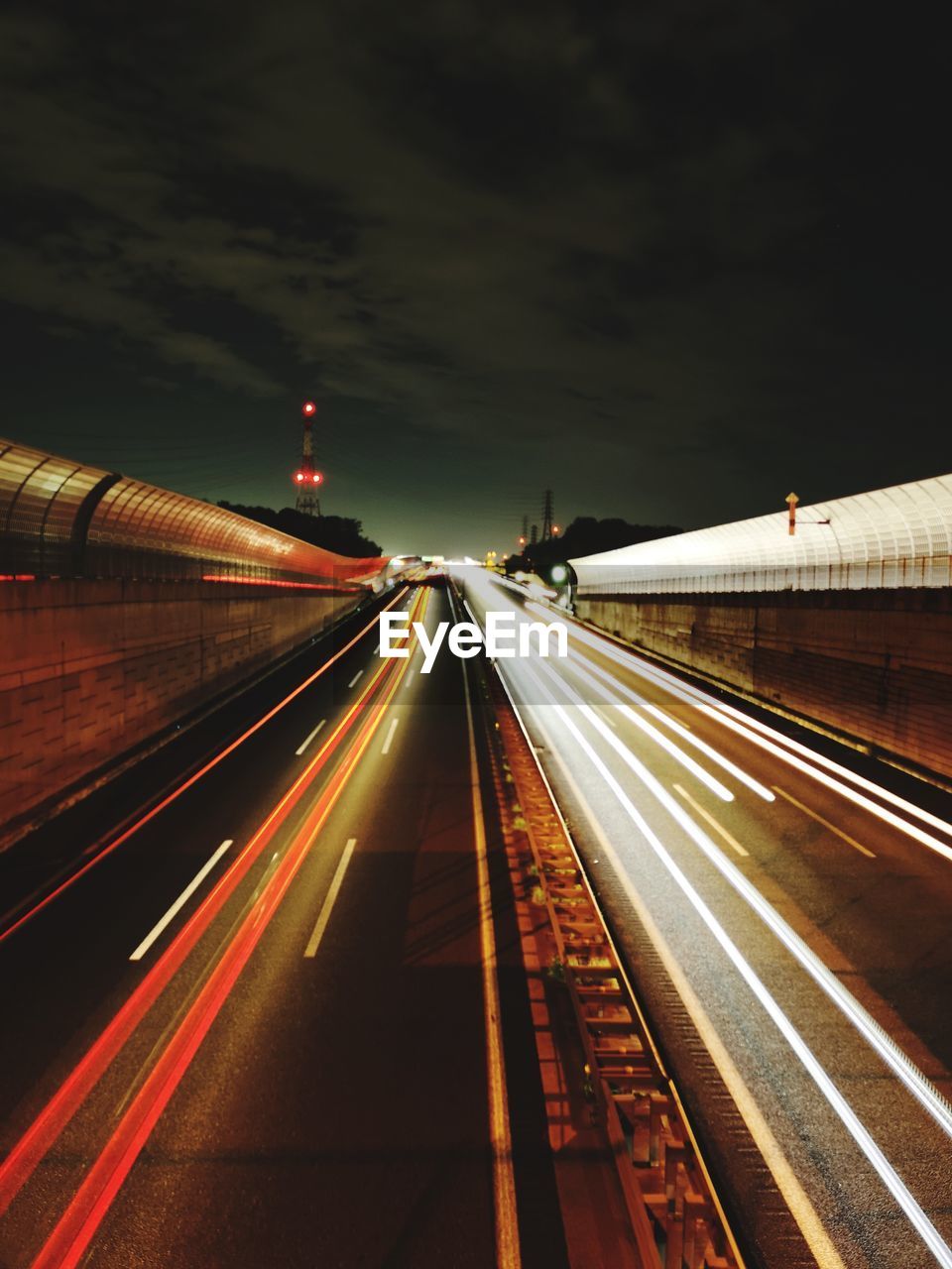 LIGHT TRAILS ON ROAD AT NIGHT