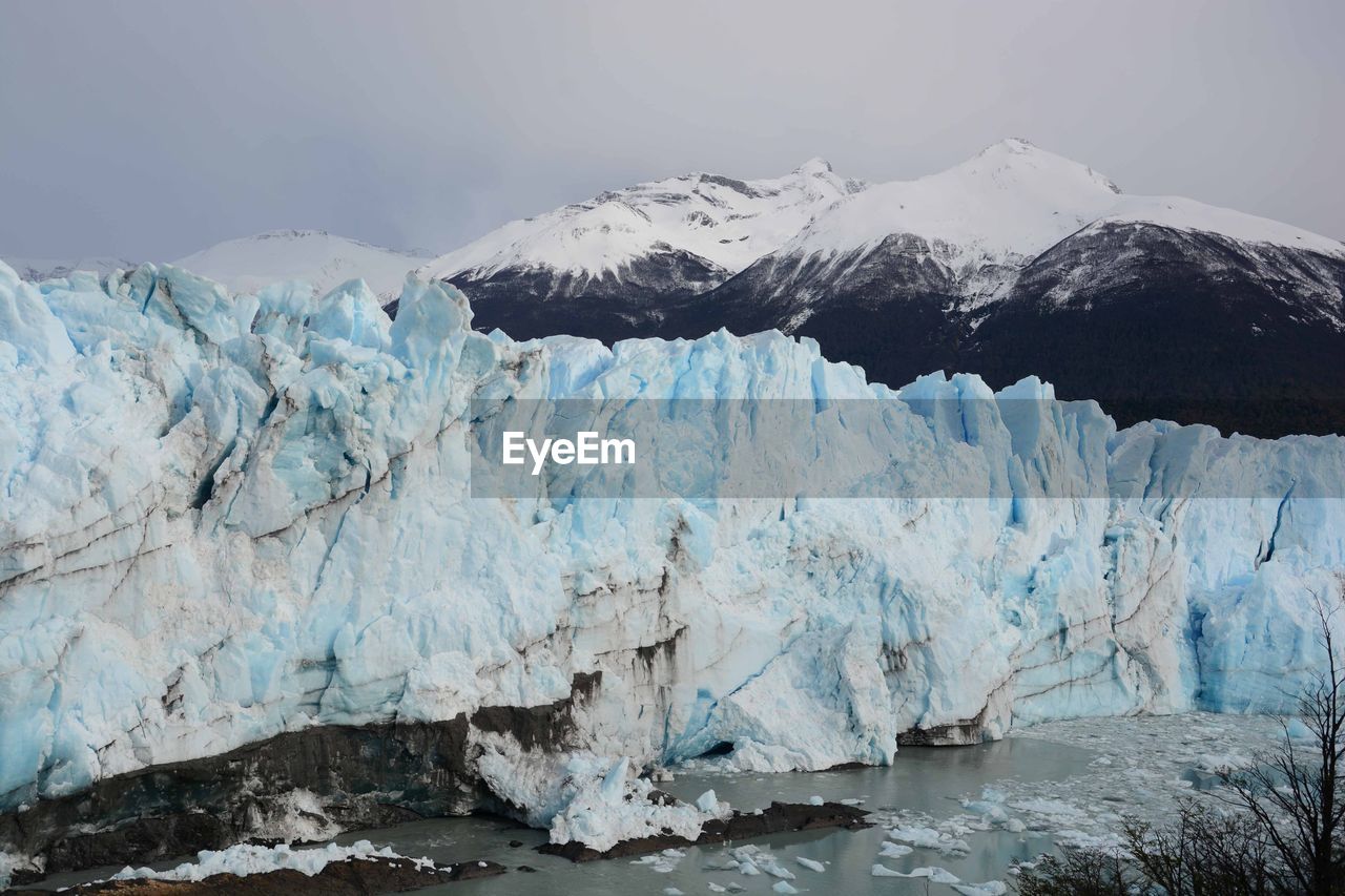 Moreno glacier with snowcapped mountains in background