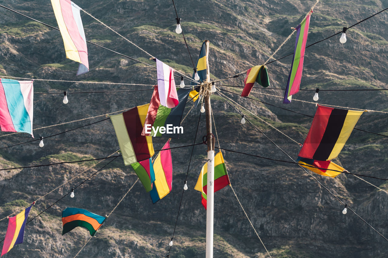 Various flags against mountain