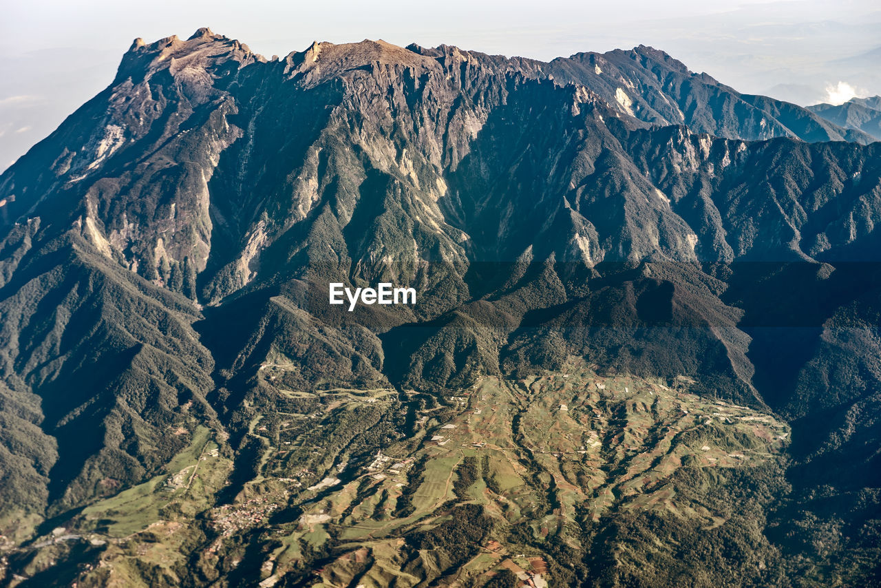 AERIAL VIEW OF MOUNTAIN RANGE AGAINST SKY