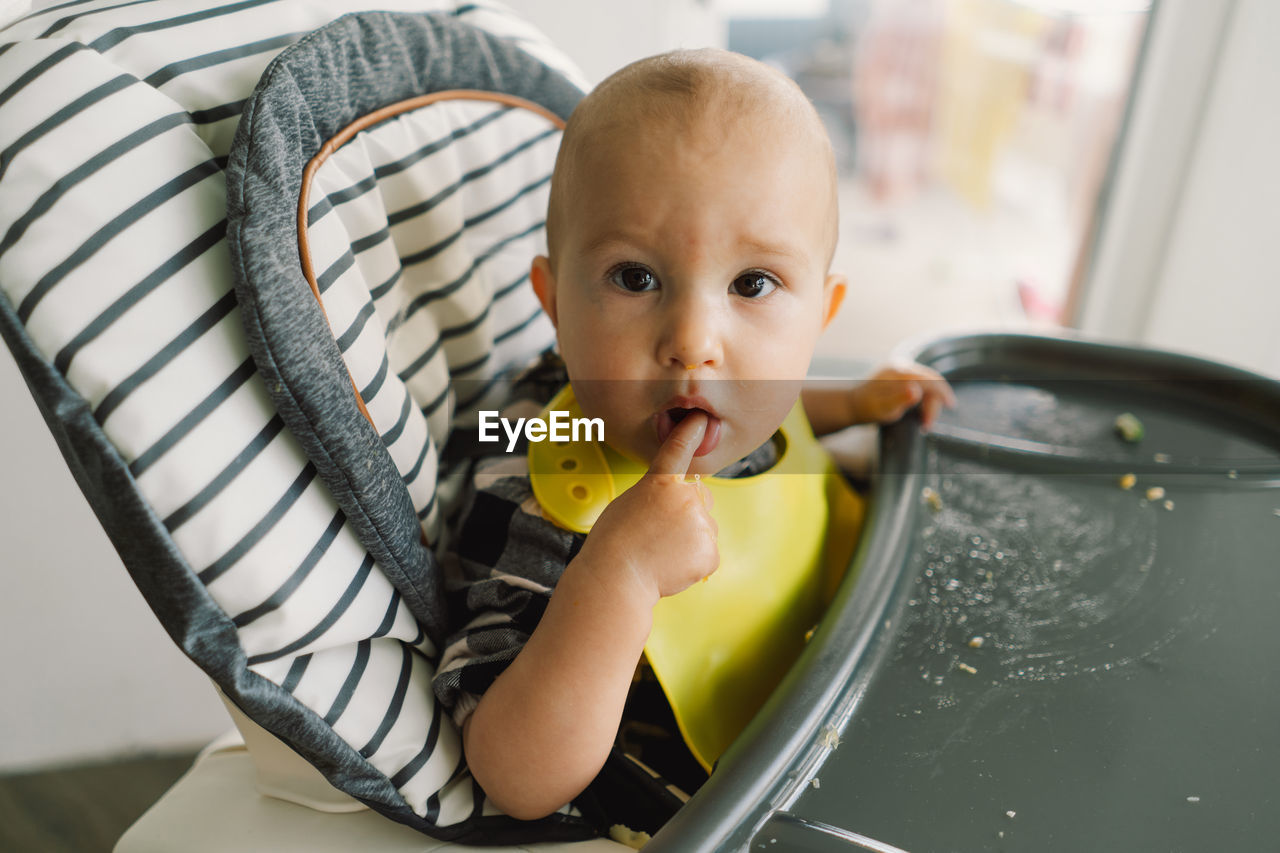 Little child with solid nutrition. baby girl eating food and mix vegetable plate