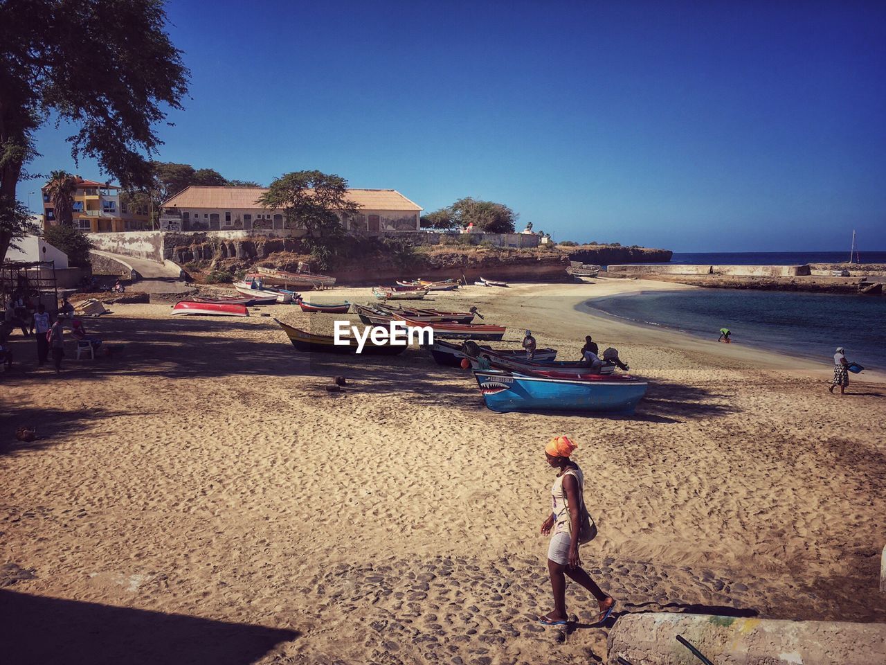 PEOPLE AT BEACH AGAINST CLEAR SKY