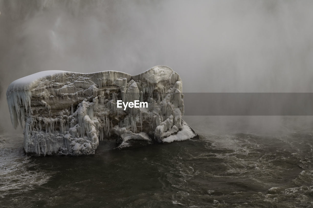 An icy build up at the base of the horseshoe falls in niagara falls, ontario, canada.