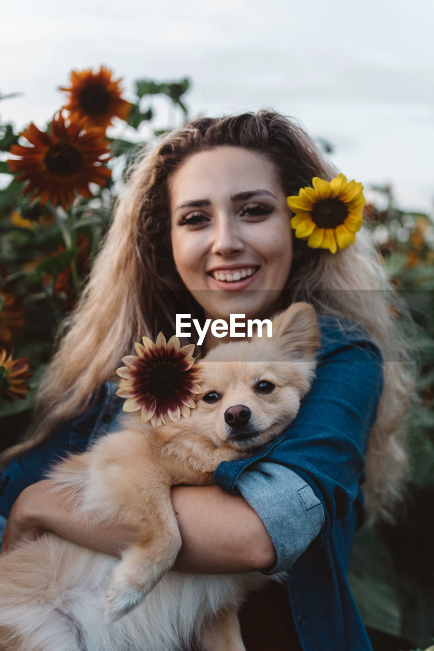 Portrait of young woman with dog