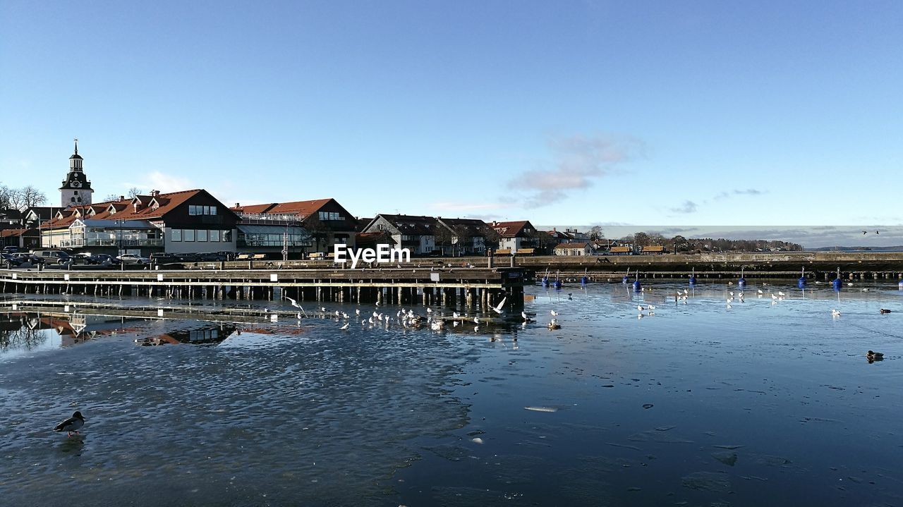 SCENIC VIEW OF SEA BY BUILDINGS AGAINST SKY