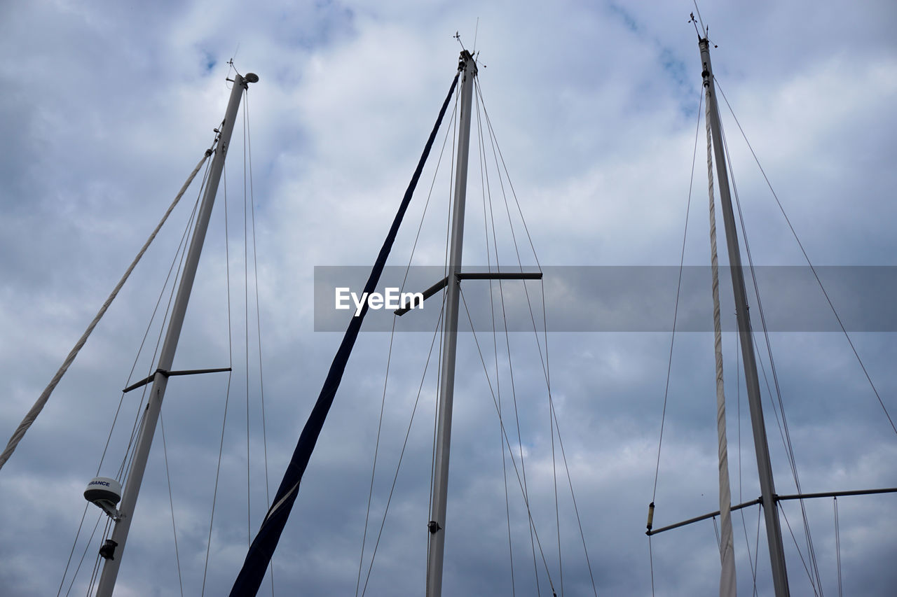 Low angle view of sailboat mast against sky