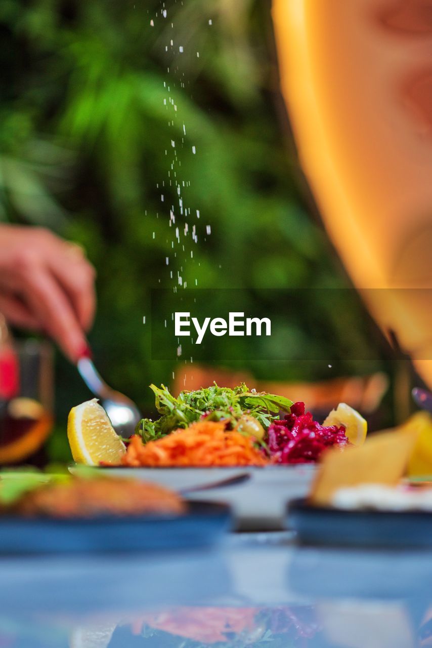 Cropped hand of woman preparing food