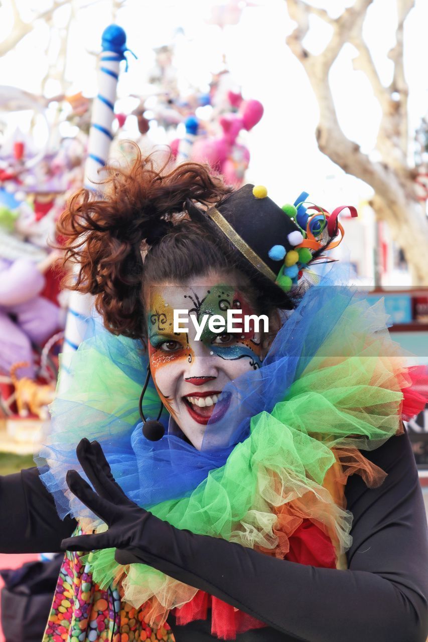 Portrait of happy mid adult woman in face paint standing outdoors