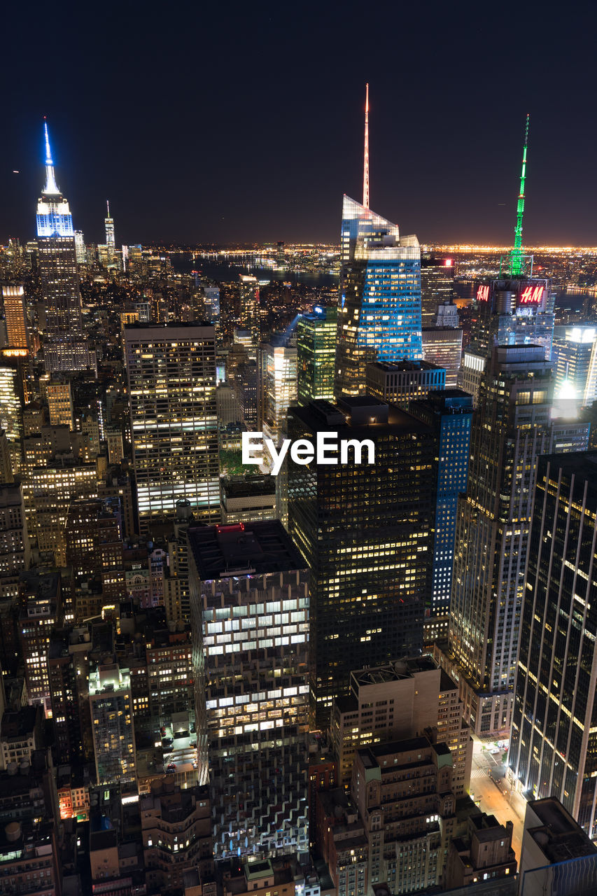 AERIAL VIEW OF ILLUMINATED BUILDINGS IN CITY