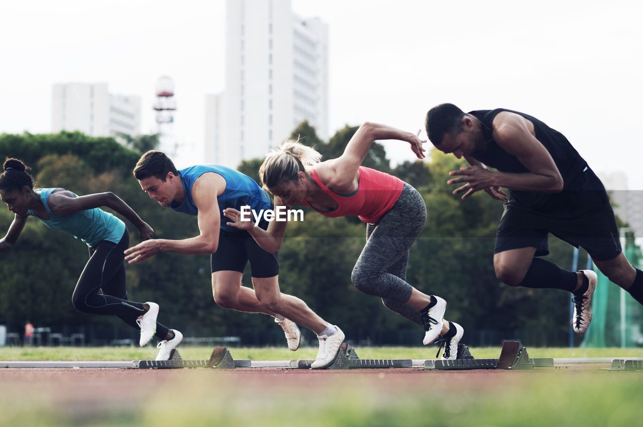 Athletes running from starting blocks on track