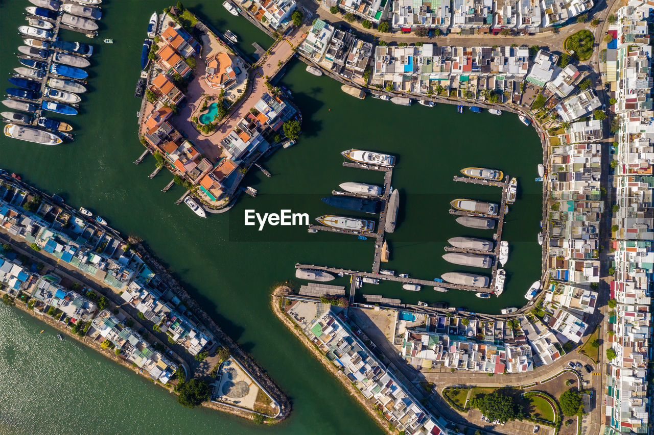 Aerial view of boats moored by cityscape