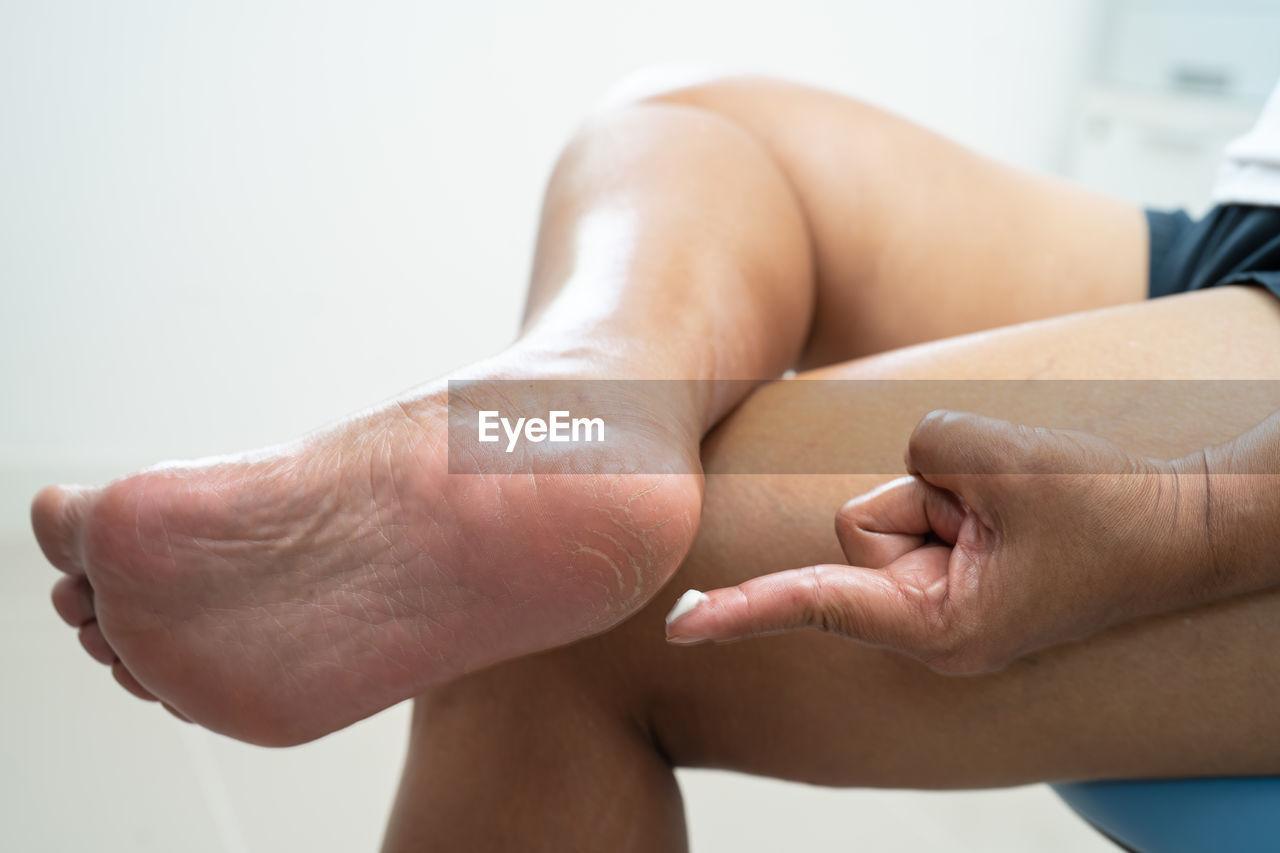 low section of woman massaging customer in bathroom