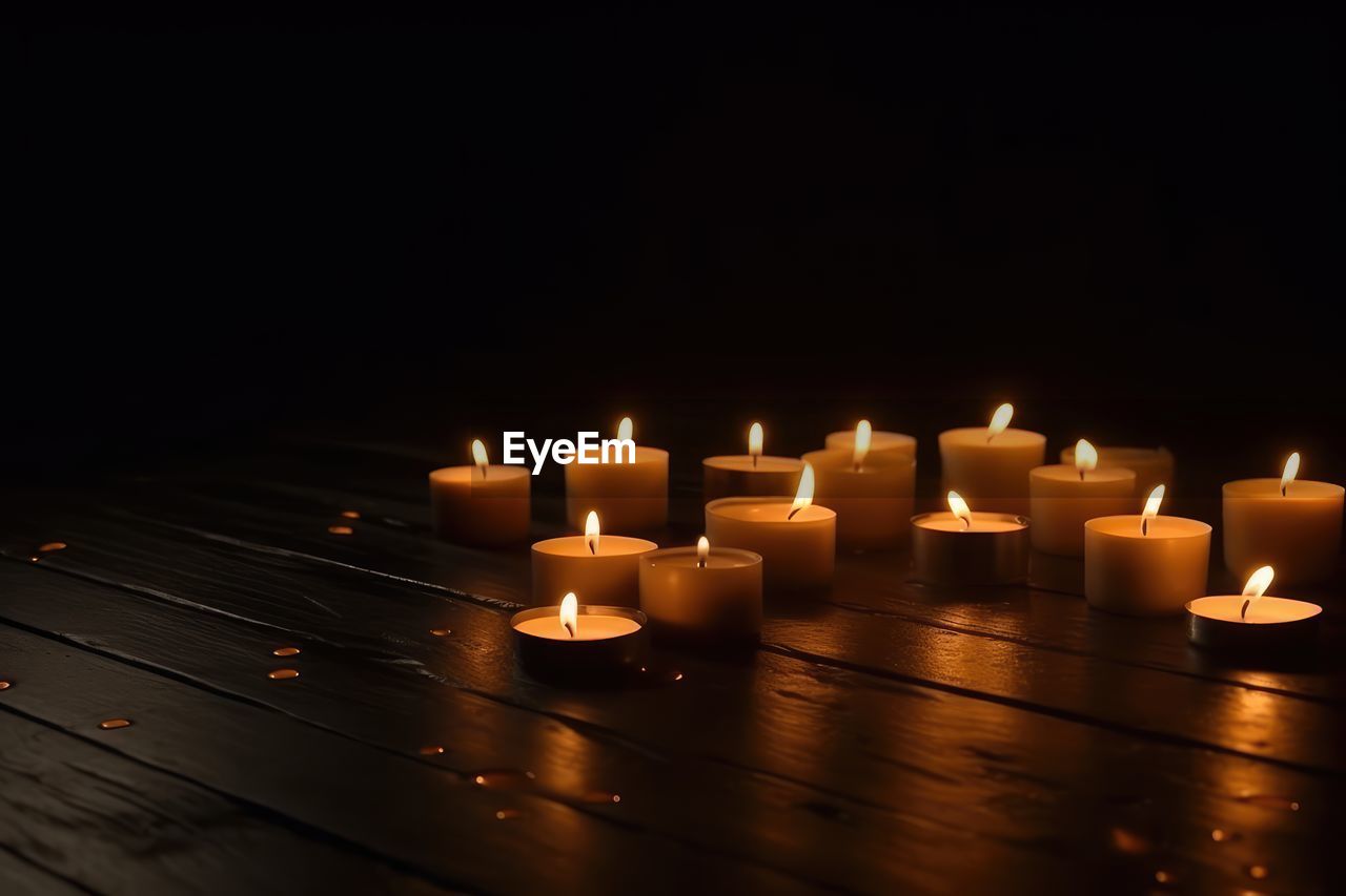 high angle view of illuminated candles on table