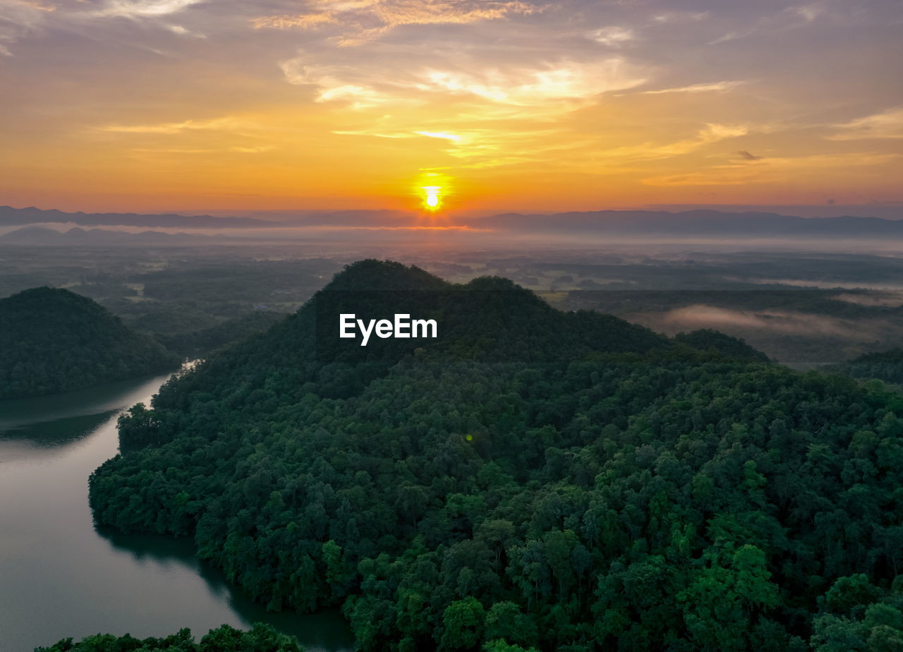 Beautiful landscape of green mountains and lake in the morning with sunrise sky. nature landscape