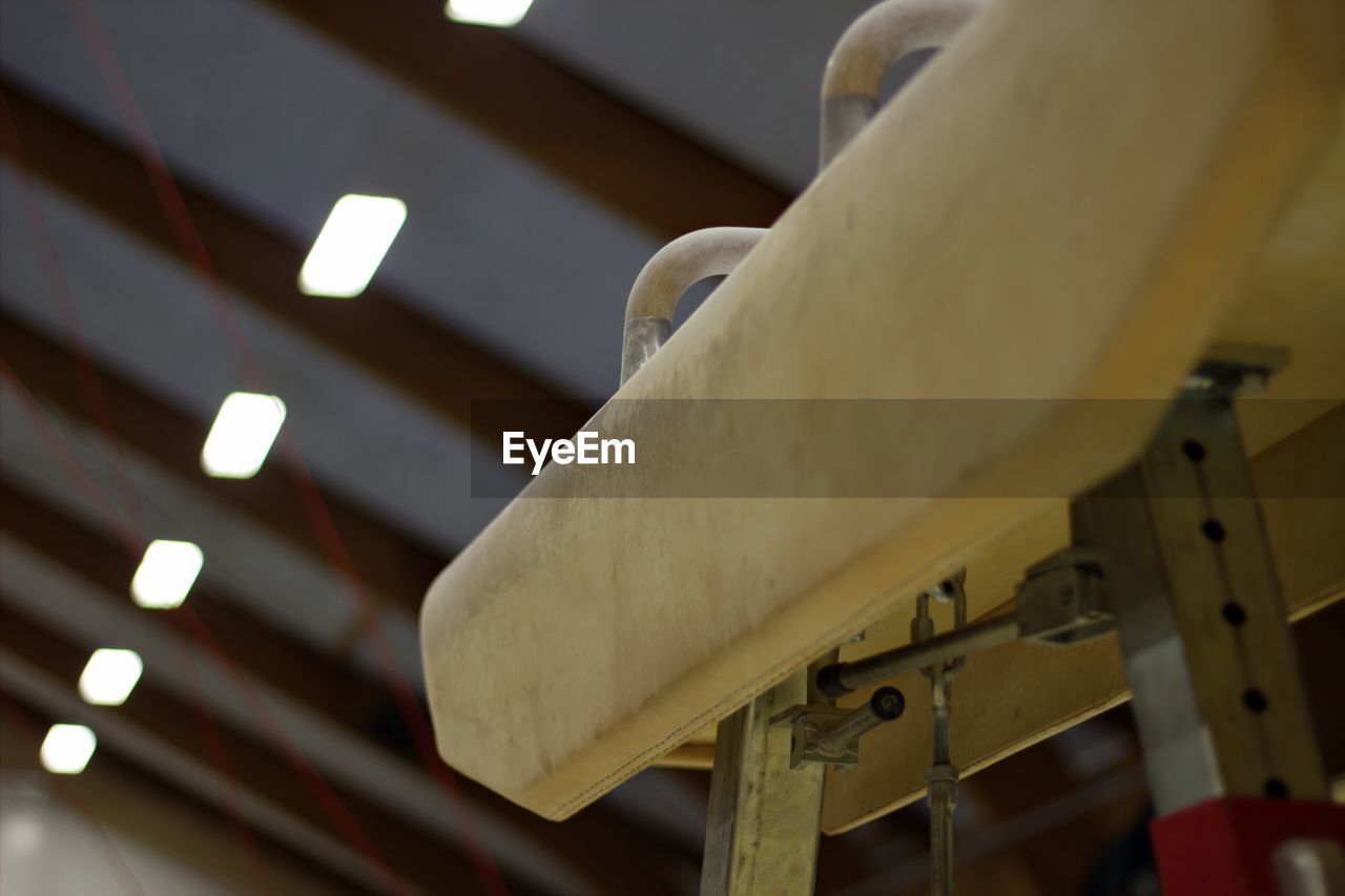 LOW ANGLE VIEW OF ILLUMINATED LIGHTING EQUIPMENT HANGING IN CEILING