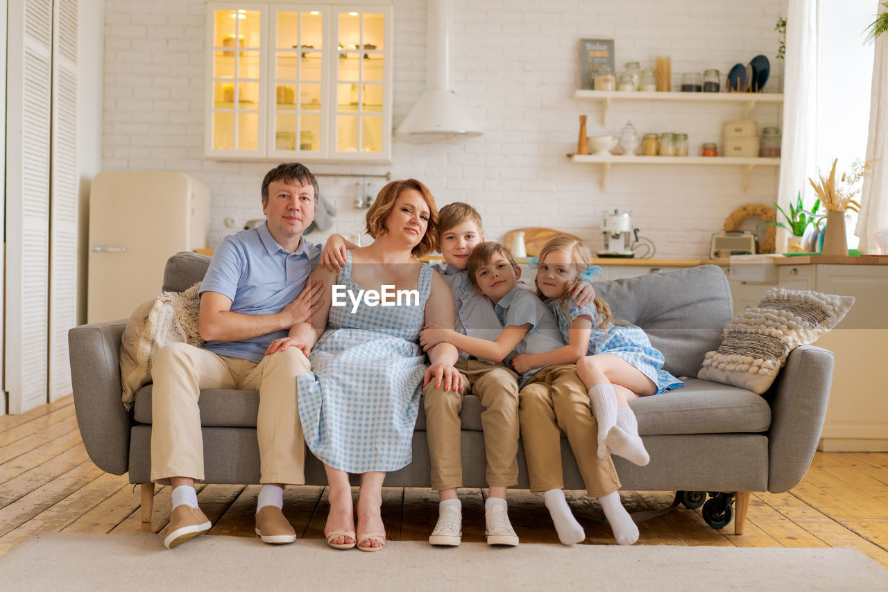 Christian big family. large family at home on sofa in living room. family