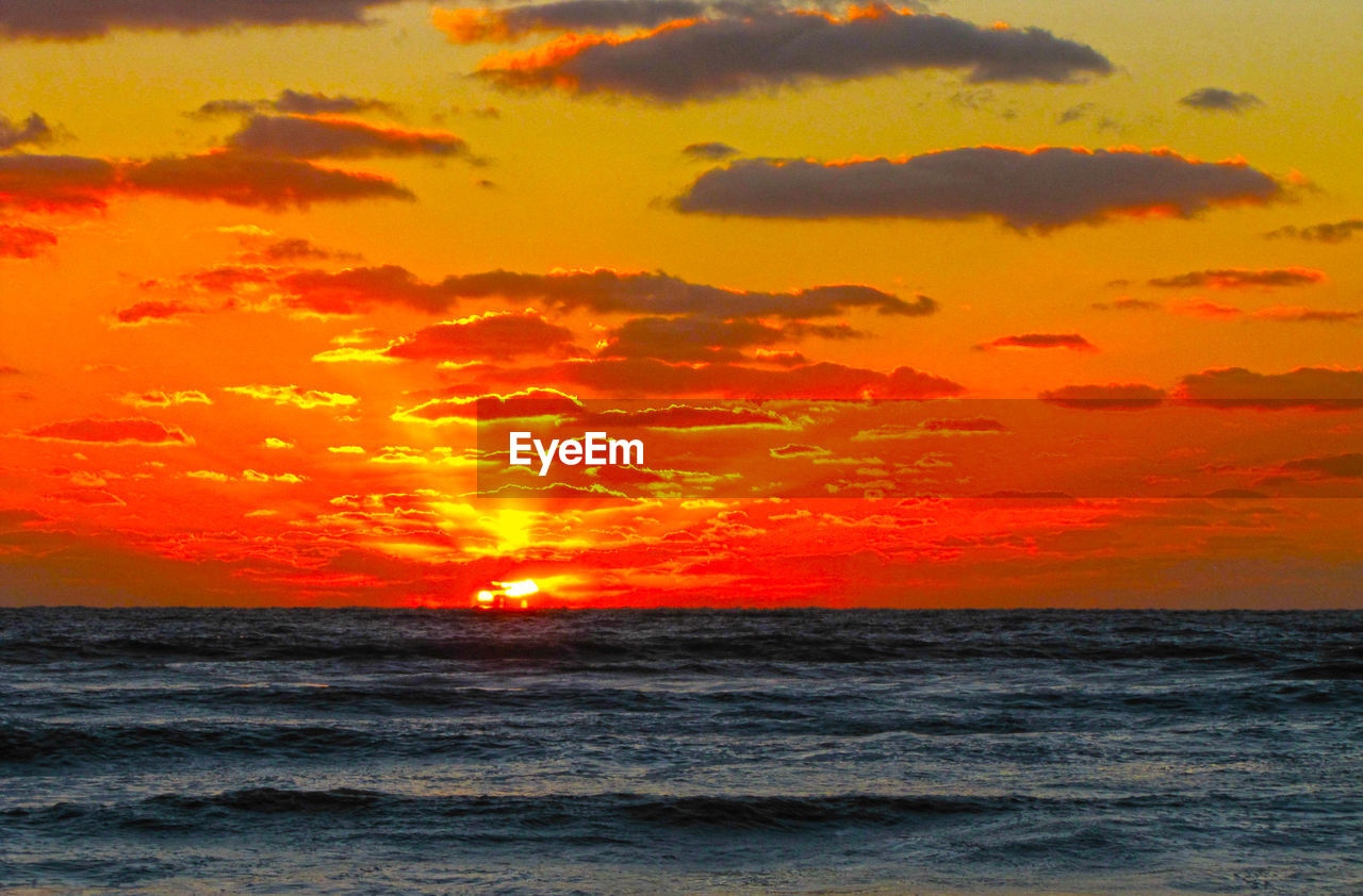 SCENIC VIEW OF SEA AGAINST ORANGE SKY