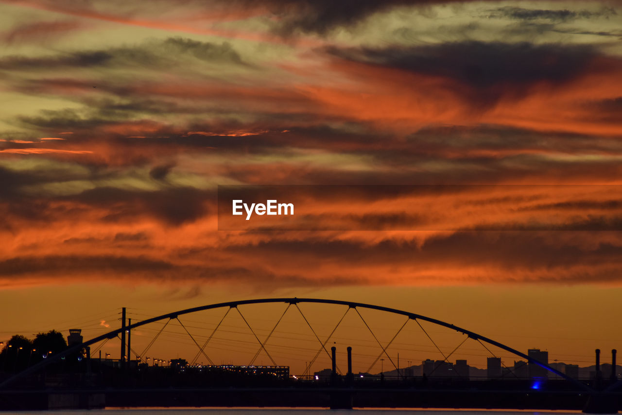 SILHOUETTE BRIDGE AGAINST DRAMATIC SKY