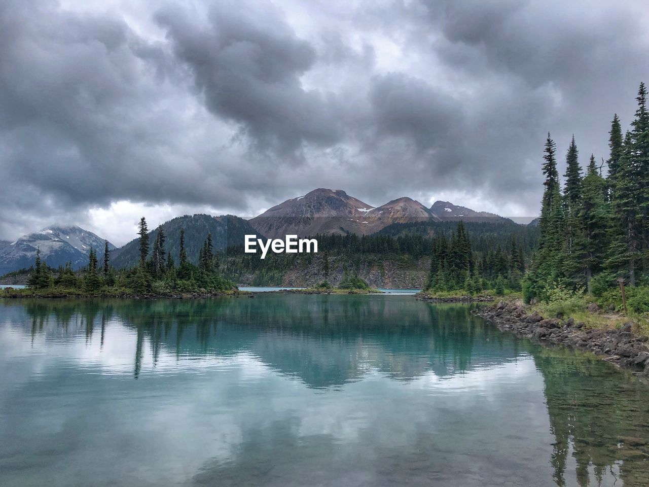 Scenic view of lake and mountains against sky