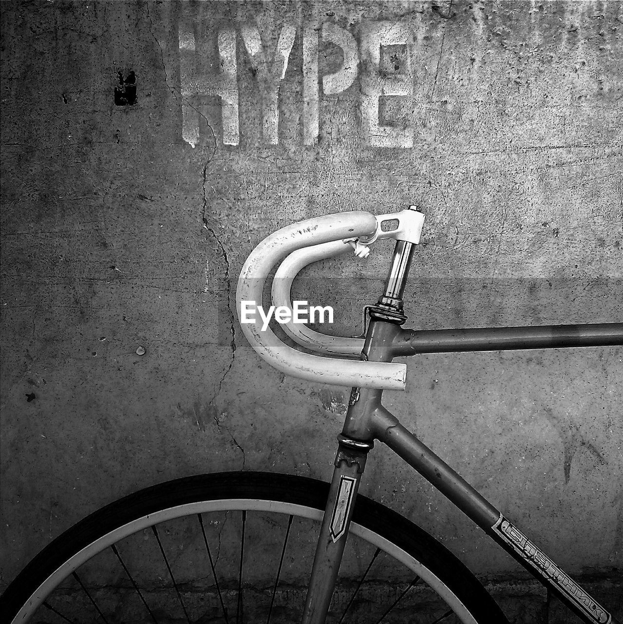 Cropped image of abandoned bicycle against wall
