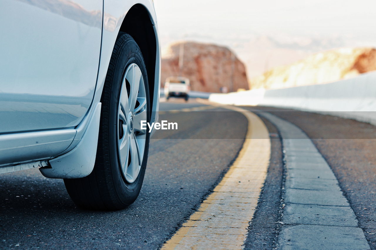 Close-up of car on road