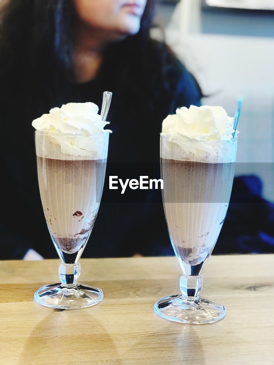 CLOSE-UP OF ICE CREAM WITH JUICE ON TABLE