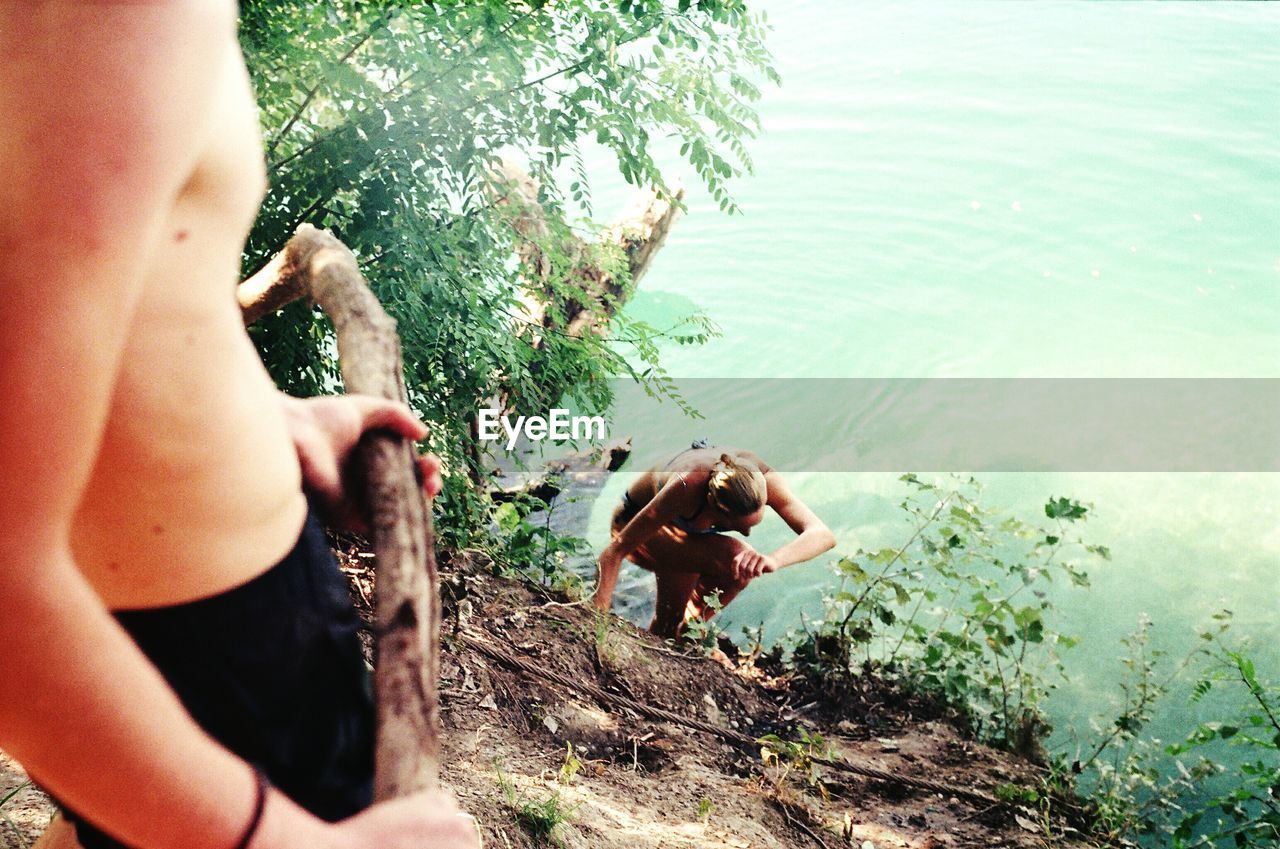 High angle view of man and woman at lakeshore