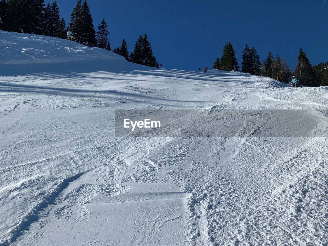 Snow covered landscape against sky