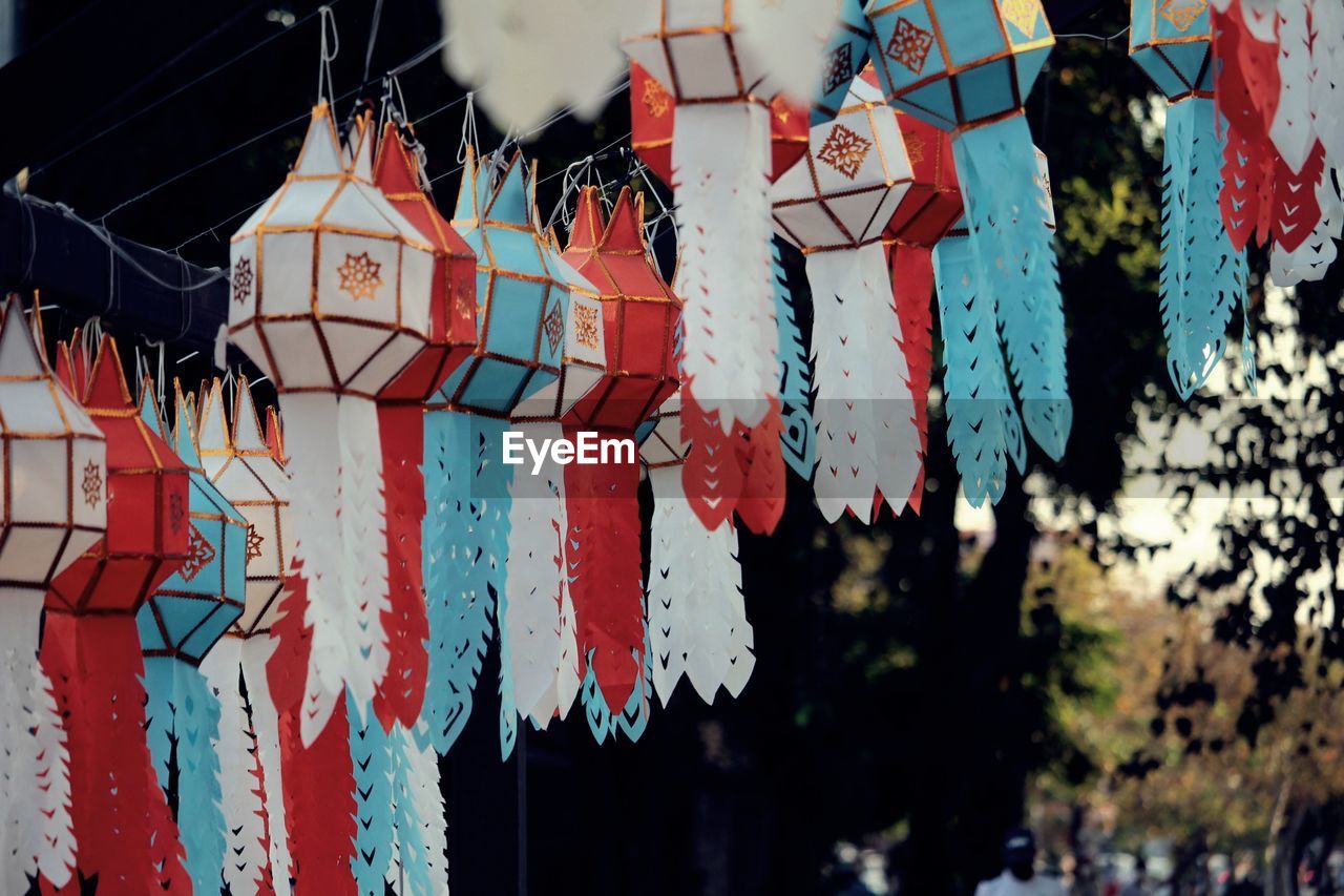 hanging, architecture, built structure, building exterior, no people, multi colored, day, art, decoration, tradition, outdoors, red, creativity, city, nature, building, celebration, low angle view