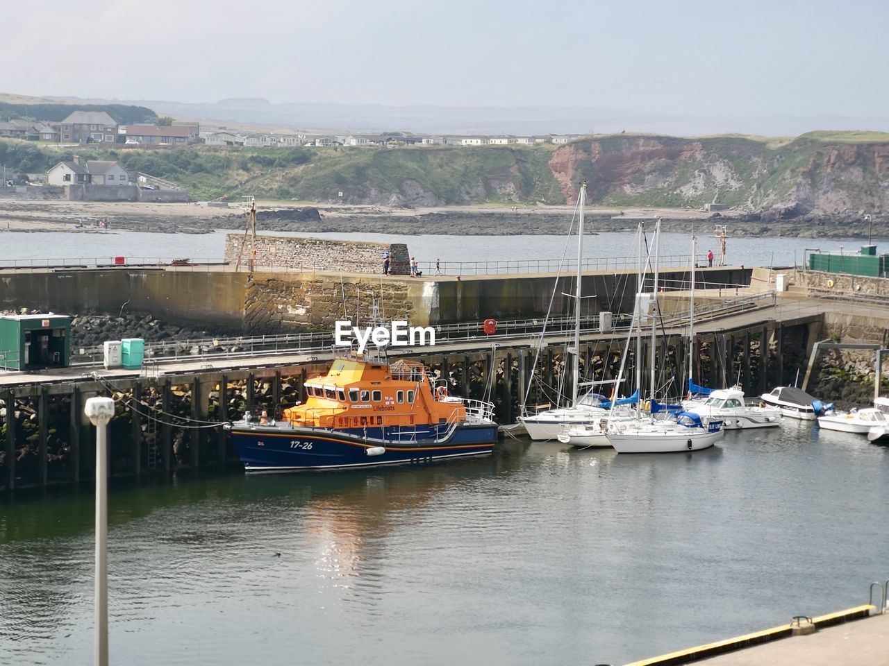 BOATS MOORED IN BAY