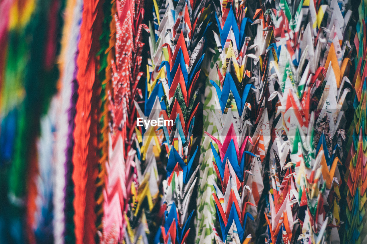 Close-up of multi colored origami swans for sale