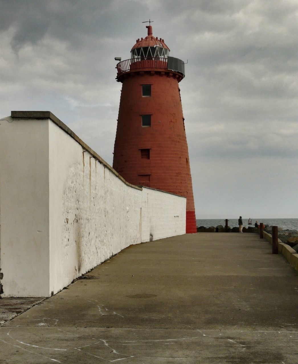 View of lighthouse against calm sea and sky