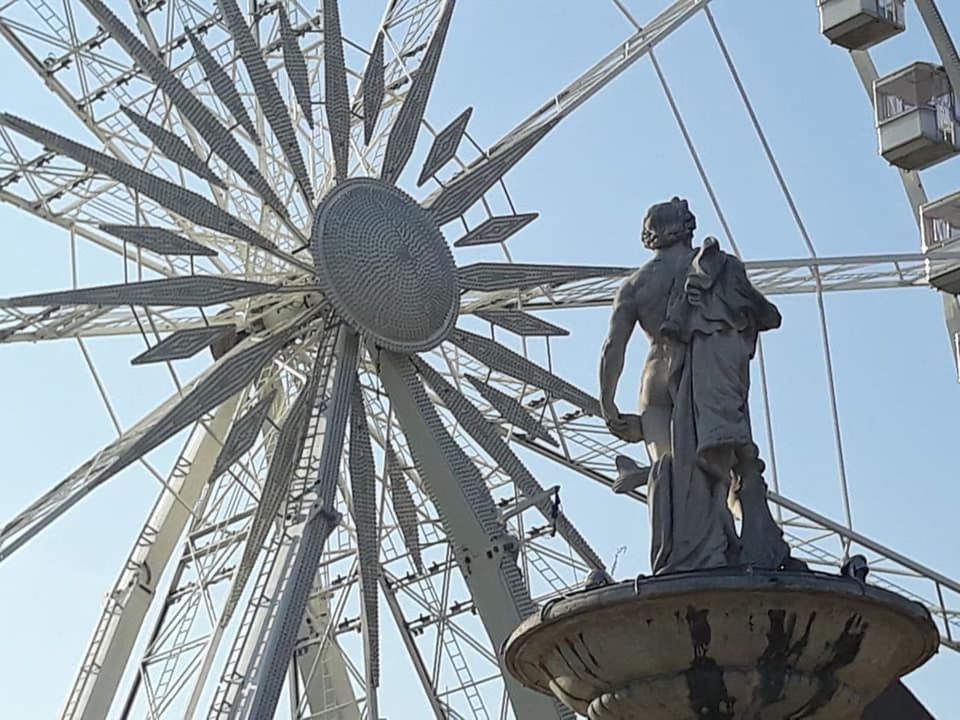 sky, low angle view, architecture, ferris wheel, nature, day, mast, clear sky, outdoors, built structure, person, electricity, vehicle, men, occupation, power generation